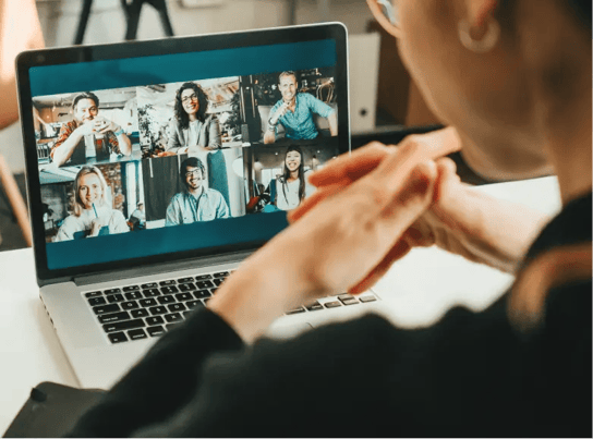 Man sitting on front of laptop in hand on face thinking.