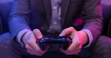 A pair of hands holding a game controller.