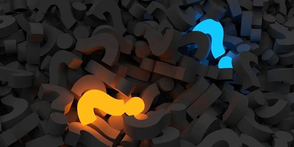 A pile of question marks with one yellow and one blue highlighted